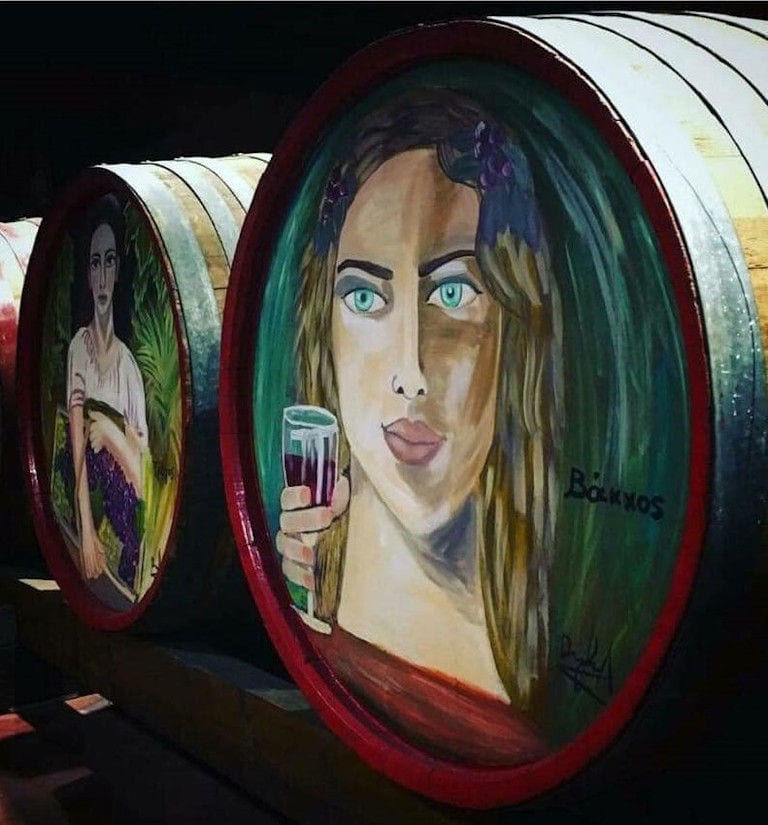 Painted wood barrels representing a face of girl at 'Lykos Winery' cellar